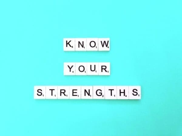 Know your strengths quote Know your strengths quote spelled with word scramble cubes on blue background