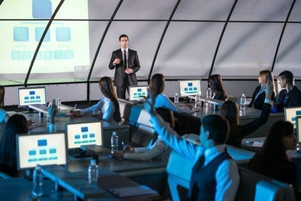 Businessman presenting in a training room full of business people