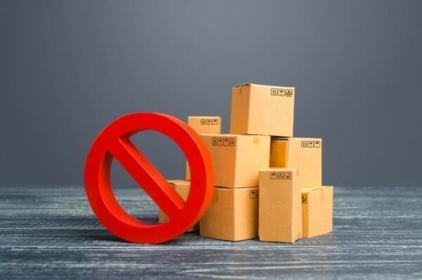 Pile of cardboard boxes with a no entry sign in front