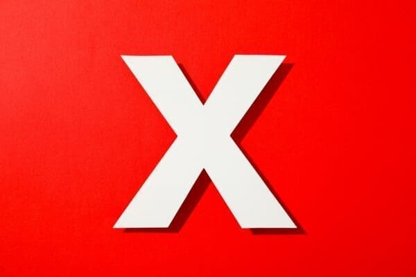 White letter X on a red background