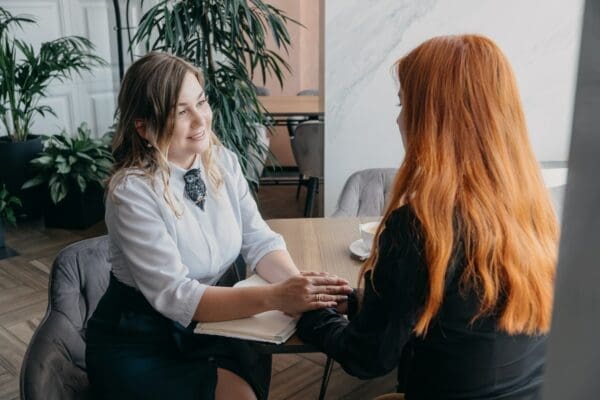 Two female human resource professionals talking at a table