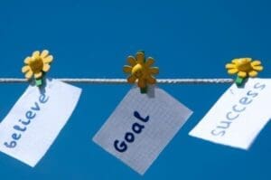 Believe, goal, and success notes pinned to a line