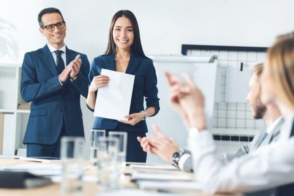 Manager presenting a happy employee with an employee recognition award