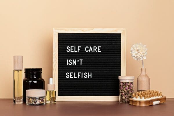 Self-care is not selfish framed quote with body and mind care products for self-care
