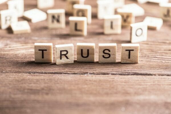 Trust spelled with wooden word scramble cubes