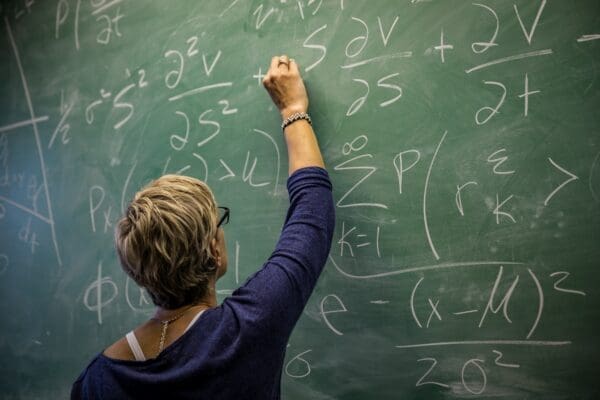 Woman teacher working on the chalkboard