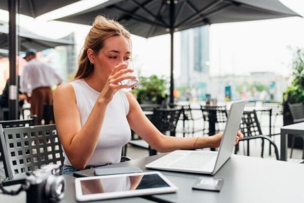 Flexible female remote worker working outside a cafe
