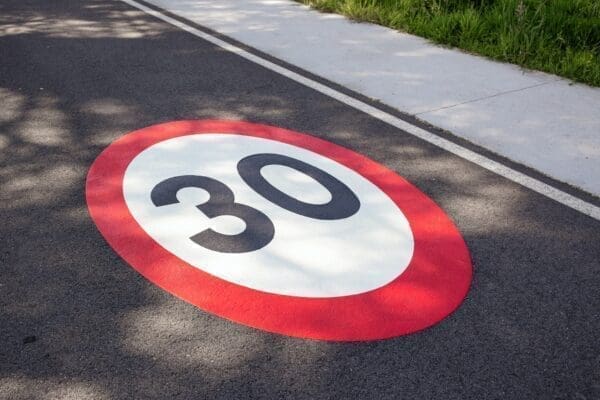 30 miles per hour speed limit sign on the road