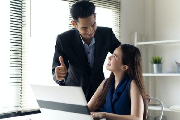 Business man leader giving congratulations and support to businesswoman