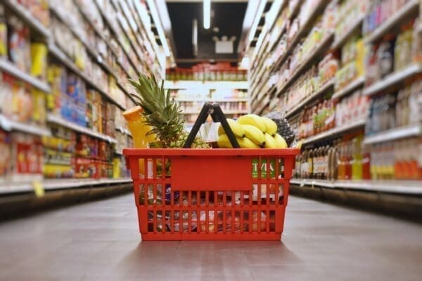 Red Groceries basket in a UK supermarket isle