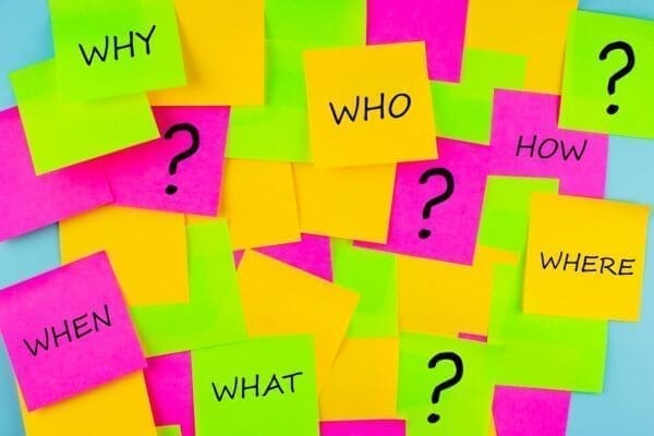 Post it notes with who what why how where questions on them