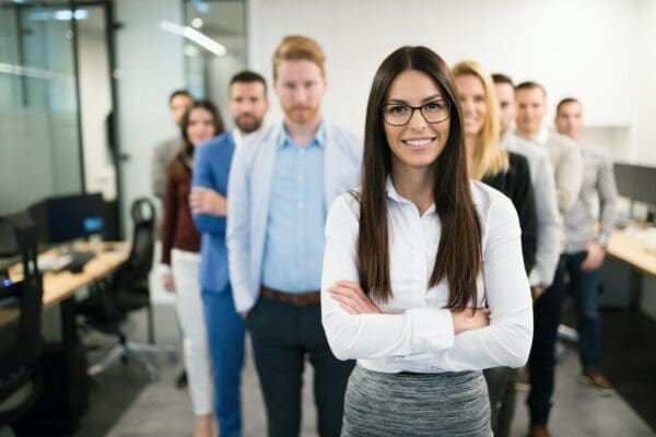 Business woman in front of other employees