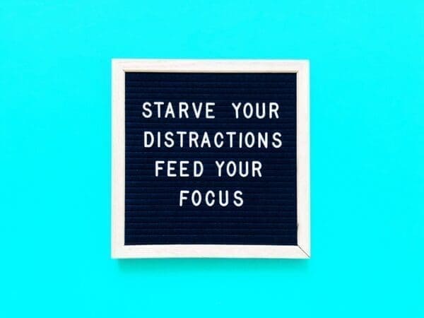 Starve your distractions feed your focus quote on blue background