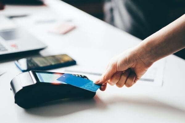 Customer using contactless payment in a UK grocery store