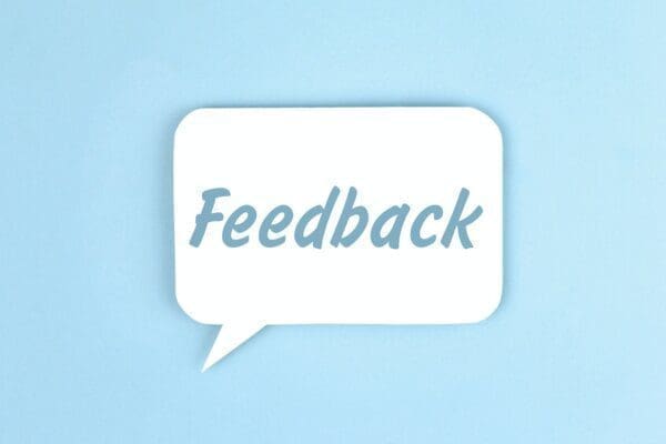 Feedback in a white speech bubble on light blue background