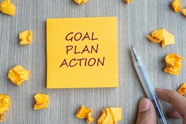 Goal plan action Goal plan action written on a yellow sticky note
