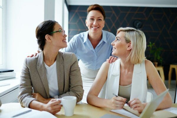 Charismatic female leader with her team of two employees