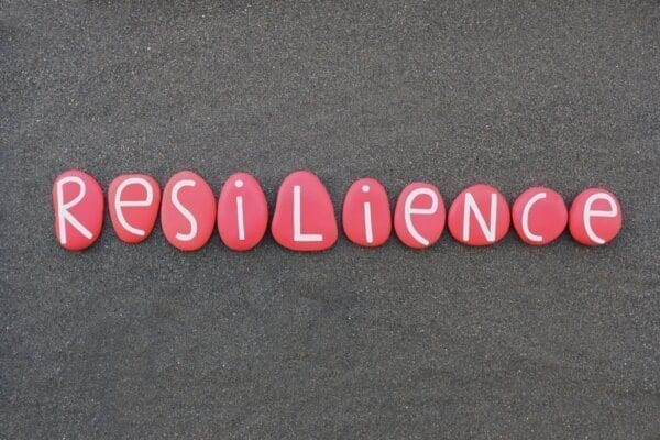 Resilience spelled with white letters on red stones