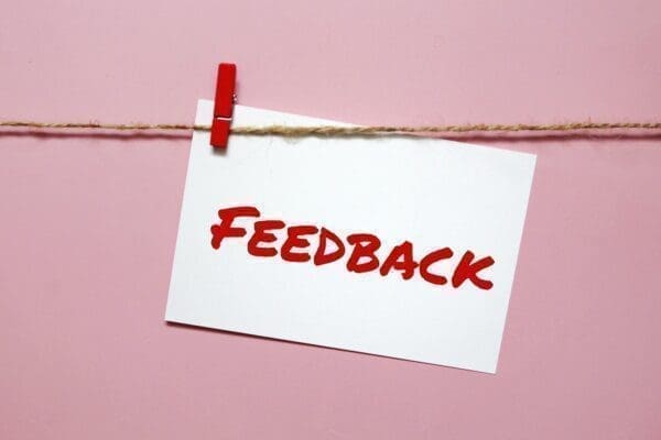 Feedback written in red on a note pinned to a line