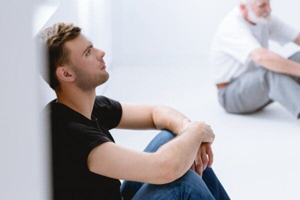 Vulnerability Two vulnerable men seated on the ground