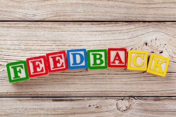Feedback spelled with colourful toy letter blocks