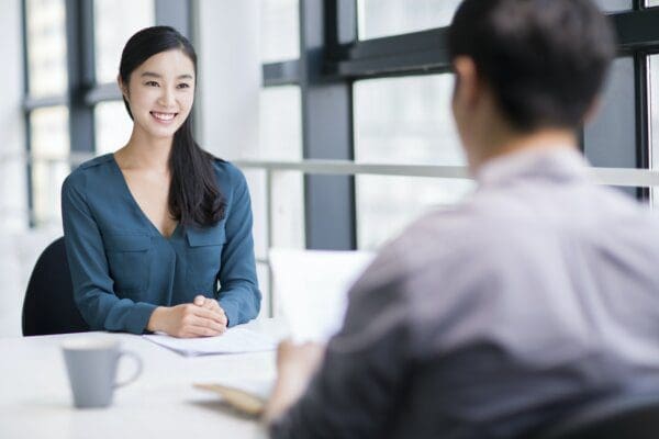 Happy young woman smiling before her manager