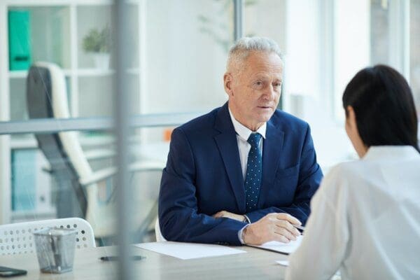 Businessman boss communicating with female employee