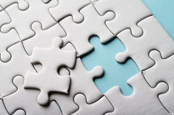 Jigsaw piece White jigsaw puzzle with one piece missing