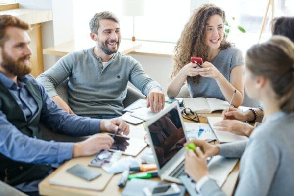 Team around a table communicating and working