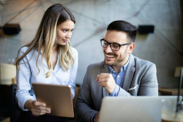 Motiving boss with a happy employee in a modern office