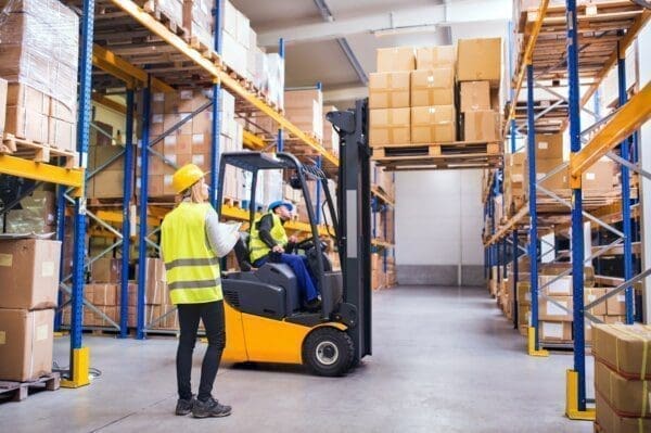 Young warehouse workers working together to look for improvements