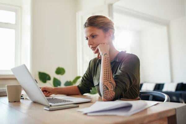 Young woman looking at laptop seriously