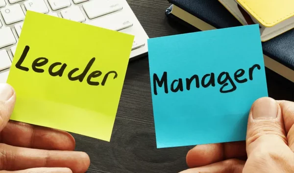 Leader vs manager written on post it notes