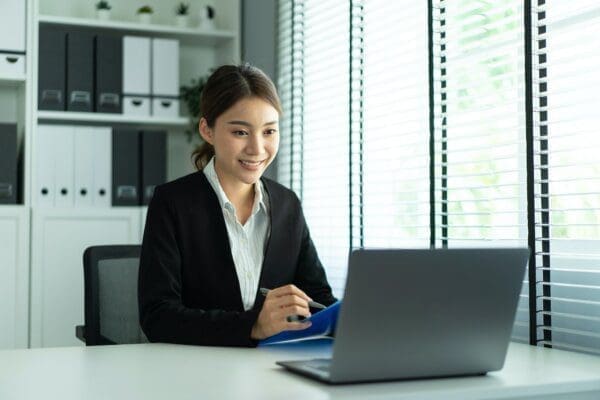 Asian businesswoman video conferencing on her laptop