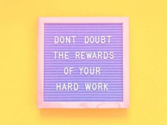 Don’t doubt the rewards of your hard work quote on felt board with yellow background