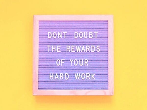 Rewards quote Don’t doubt the rewards of your hard work quote on felt board with yellow background