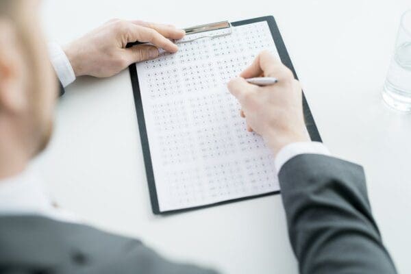 Close up of man's hand filling in a personality test 