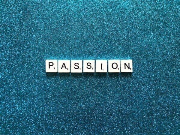 Passion Passion spelled with word scramble cubes on a blue background