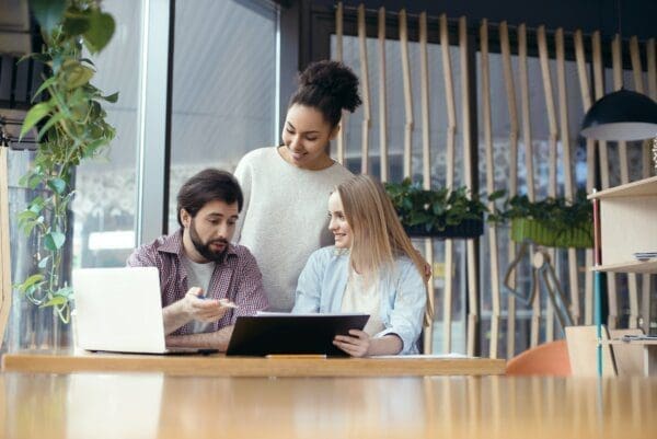 Three colleagues working together in a bright office to get clearer thoughts