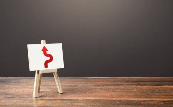 Red arrow on an easel for avoiding an obstacle