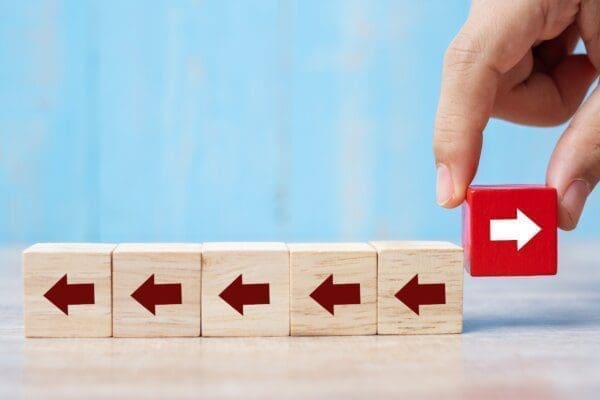 Wooden arrow blocks with one arrow pointing in a different directions