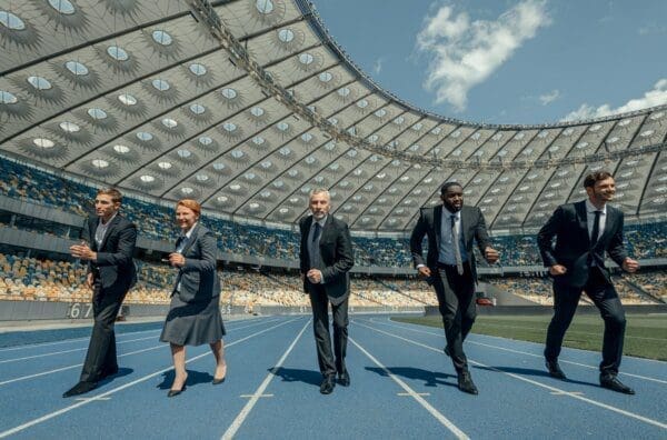 Group of business people participating in competition on a race track