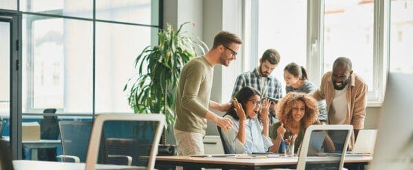 Overly-excited office workers feeling joyful about work