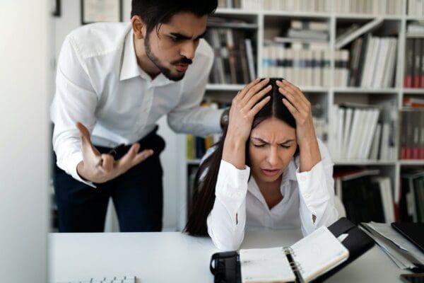 Angry boss shouting at an employee