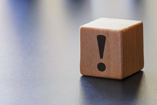 Warning block Warning exclamation mark on a wooden block