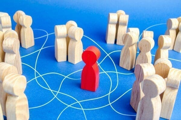 Isolated figure Red figure in the centre of many wooden figures, isolated