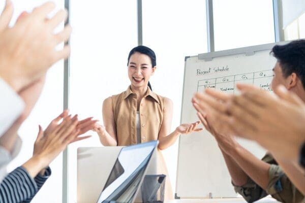 Female employee receiving praise from team