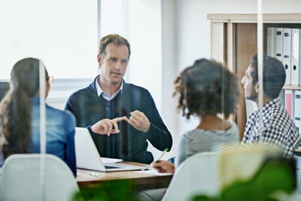 Close shot of leader outlining tasks to team members