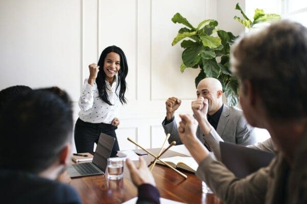 Businesswoman motivating her team members in a meeting