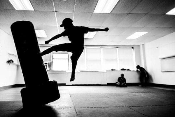 Jump kick Silhouette of a man jump kicking a punch bag